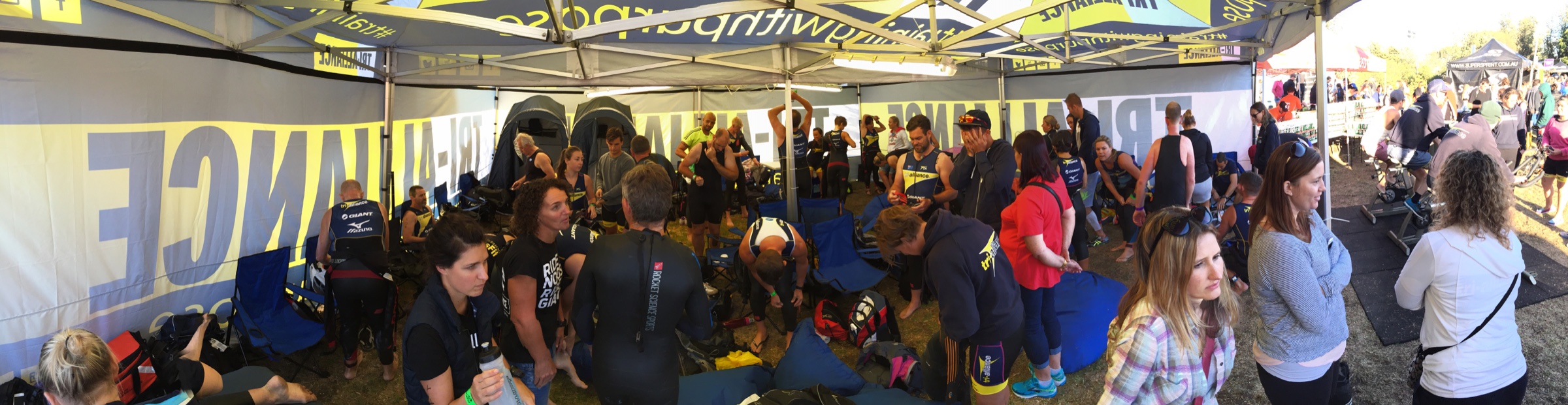 Athletes and supporters gathered inside a busy Tri Alliance race tent